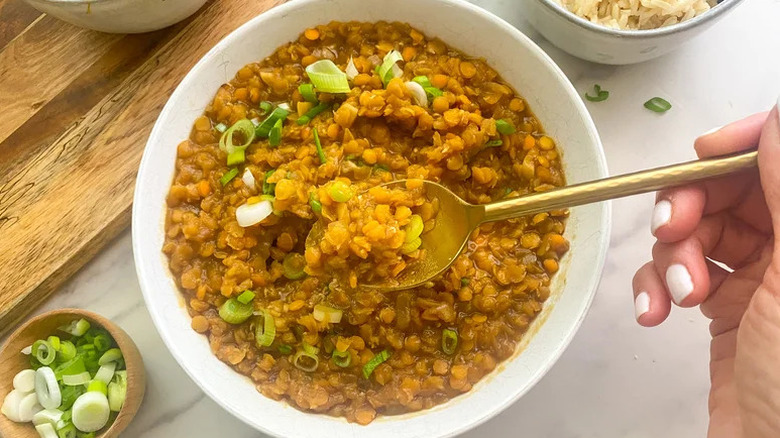 Korean BBQ-Inspired Lentils in white bowl with gold spoon