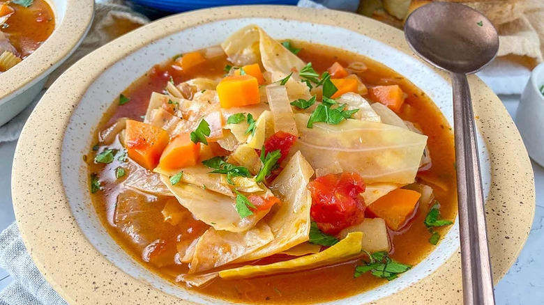 Old-Fashioned Cabbage Soup in beige and white bowl with spoon