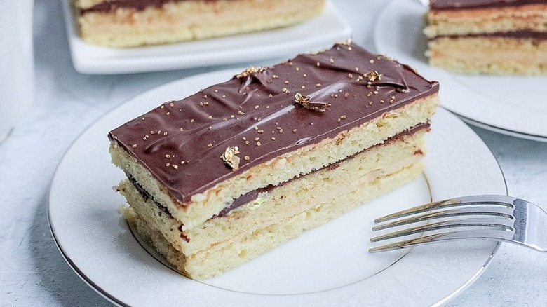Slice of opera cake on plate with fork