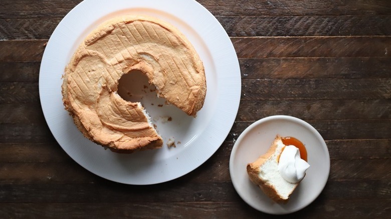 Angel food cake with slice served onto plate