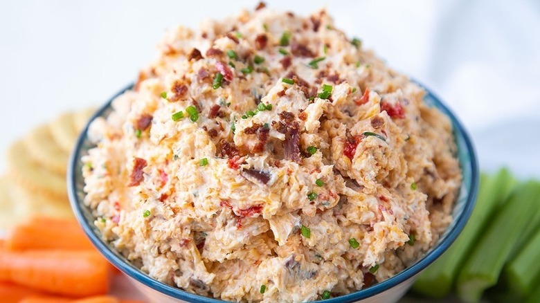 Bowl of pimento cheese, garnished with chopped chives