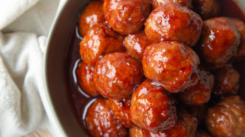 Pile of grape jelly meatballs in bowl