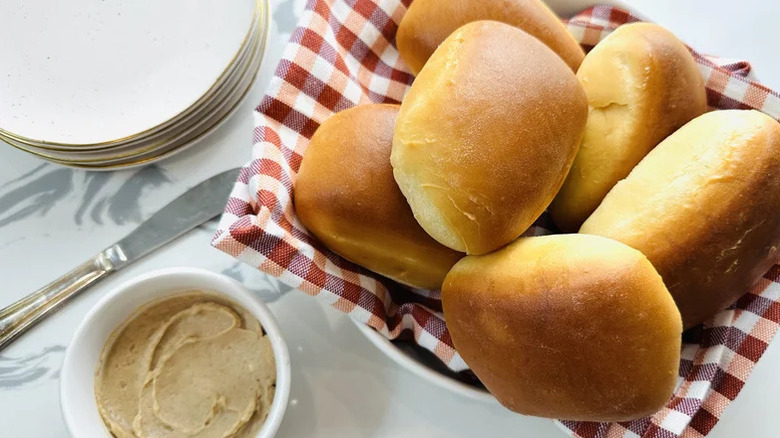Rolls in basket next to bowl of cinnamon butter