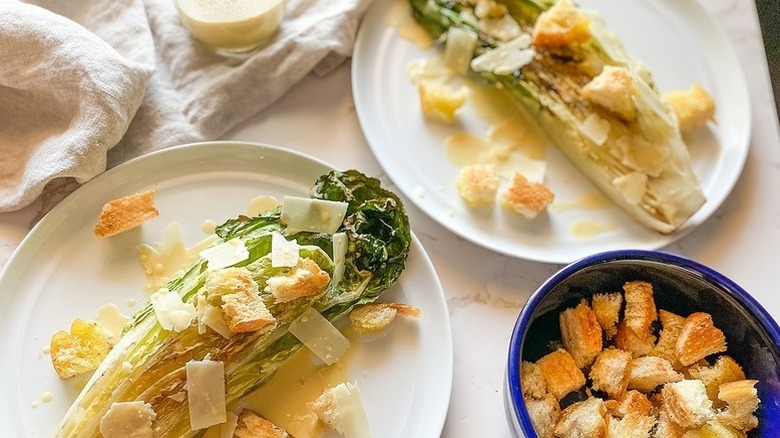 Romaine heart Caesar salads on plates