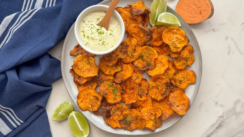 Chili Lime Sweet Potato Chips with dipping sauce on white plate