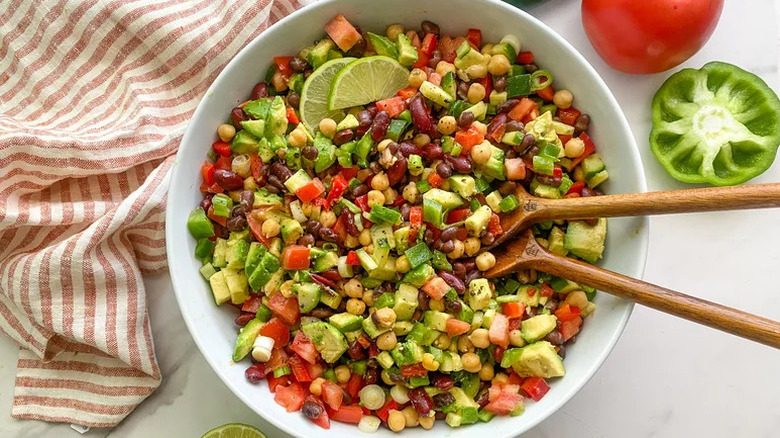 Jalapeño-Lime Three Bean Salad in white bowl with wooden spoons