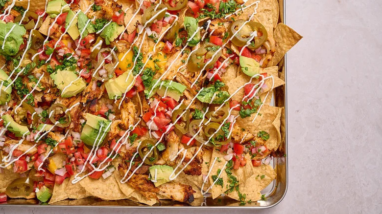 Loaded Chili-Lime Chicken Nachos on sheet pan