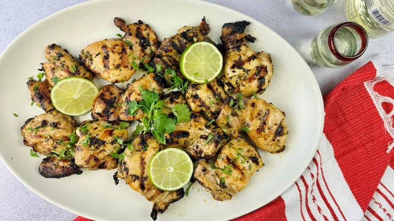 Tequila and Lime Grilled Chicken on oblong white plate with lime slices