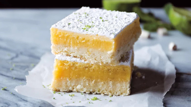 Thai Lemongrass Lime Bar Cookie stacked on white sheet of parchment paper