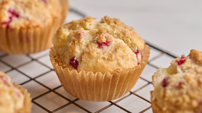Raspberry cheesecake muffins on wire cooling rack