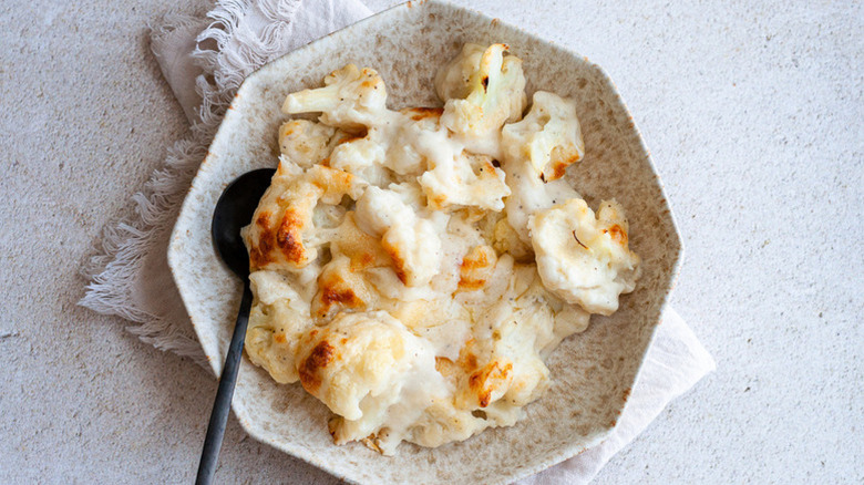 Cauliflower au gratin in bowl with spoon