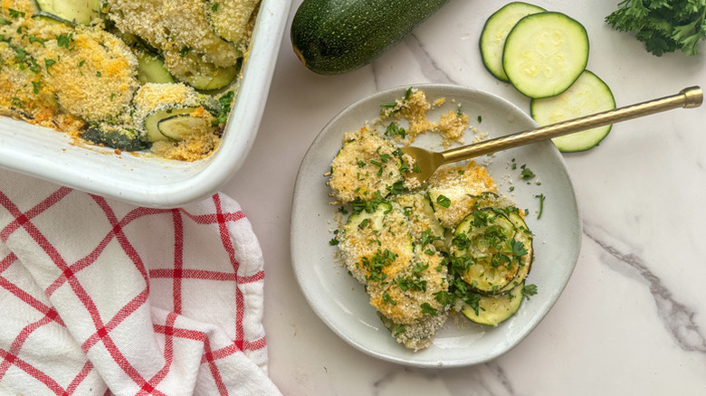 Cheesy zucchini gratin served from baking dish onto plate