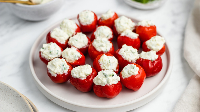 Cream cheese-stuffed cherry peppers on plate