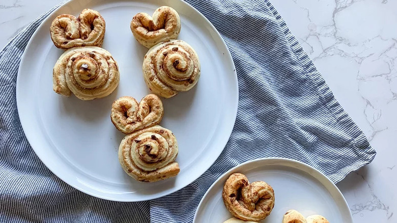 Bunny Cinnamon Rolls on white plates on towel
