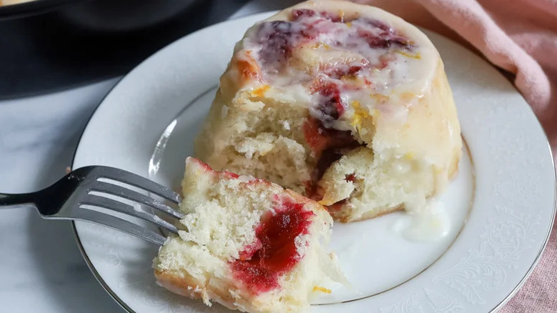 Extra Fluffy Cranberry Cinnamon Rolls on white plate with fork