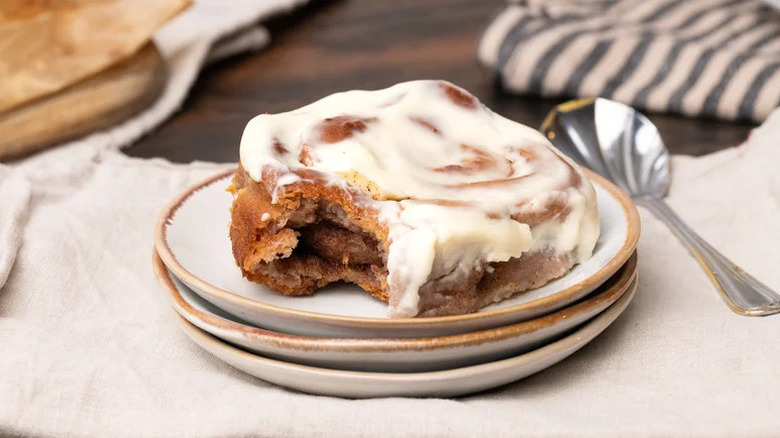 Gluten-Free Cinnamon Rolls and Cream Cheese Icing on stack of plates