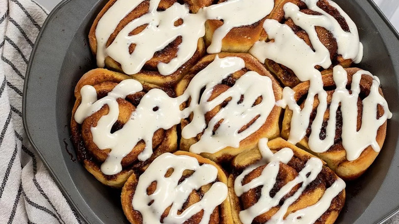 Sweet Sourdough Cinnamon Rolls in circular metal baking dish