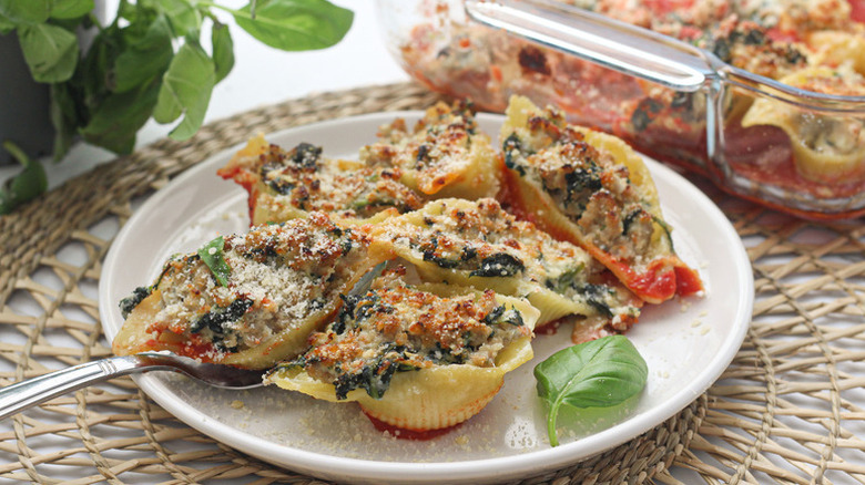 Baked spinach and ricotta-stuffed shells on plate