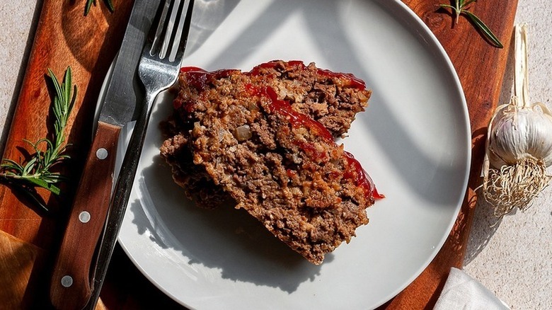 Meat loaf slices on plate with knife and fork