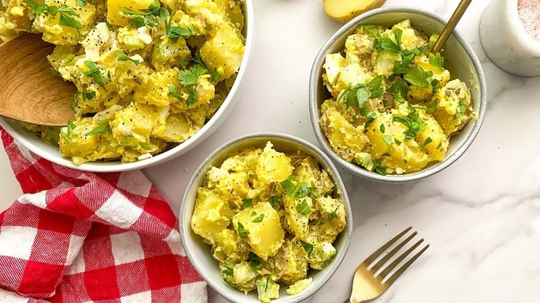 Herb-topped potato salad served into bowls