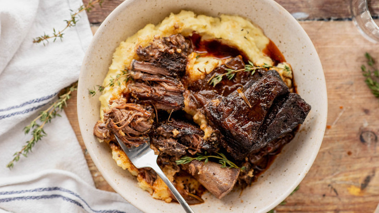 Red wine-braised beef short ribs in bowl with mashed potatoes.