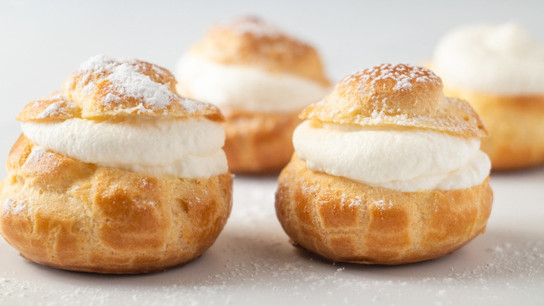 Cream puffs dusted with powdered sugar