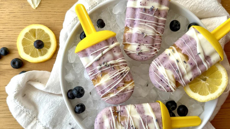 Blueberry-Lavender Honey Popsicles in bowl of ice