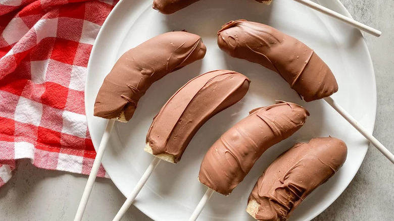 Chocolate Covered Banana Pops arranged on white plate
