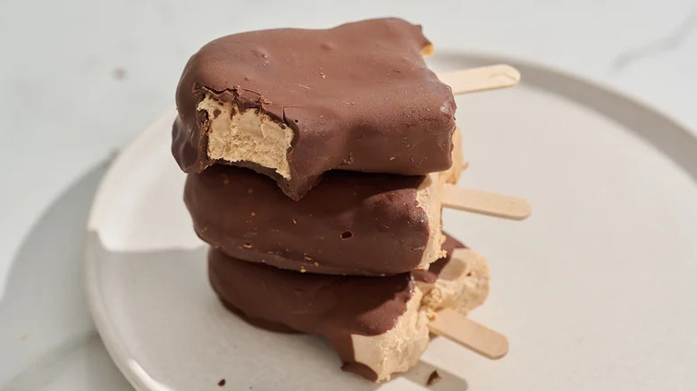 Peanut Butter Cup Yogurt Popsicles stacked on white plate