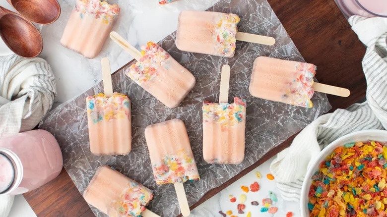 Quick and Easy Fruity Cereal Popsicles on wooden cutting board