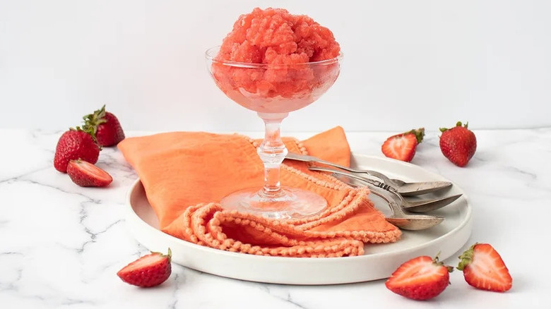 Strawberry Rose Granita in goblet stacked on napkin and white plate
