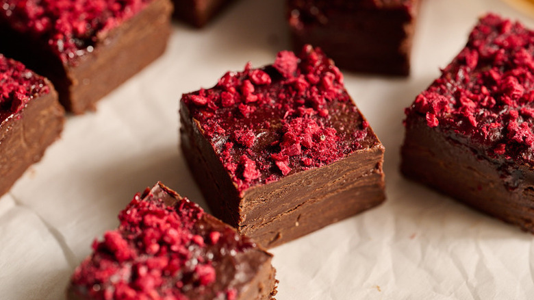Squares of chocolate fudge topped with freeze-dried raspberries