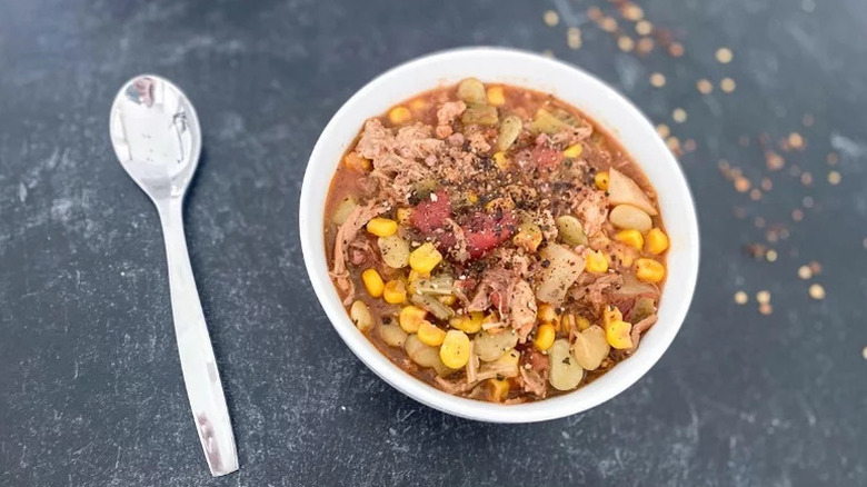 Instant Pot Brunswick Stew in white bowl with silver spoon