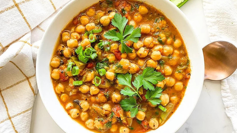 Instant Pot Chana Masala in white bowl on kitchen towel