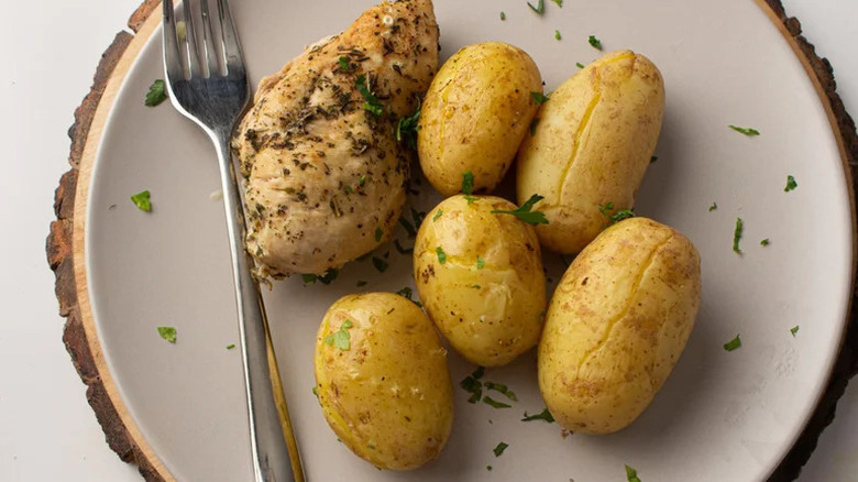 Instant Pot Chicken and Potatoes on white plate with fork