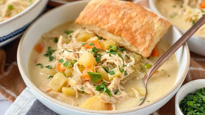 Instant Pot Chicken Pot Pie Soup in white bowl with spoon