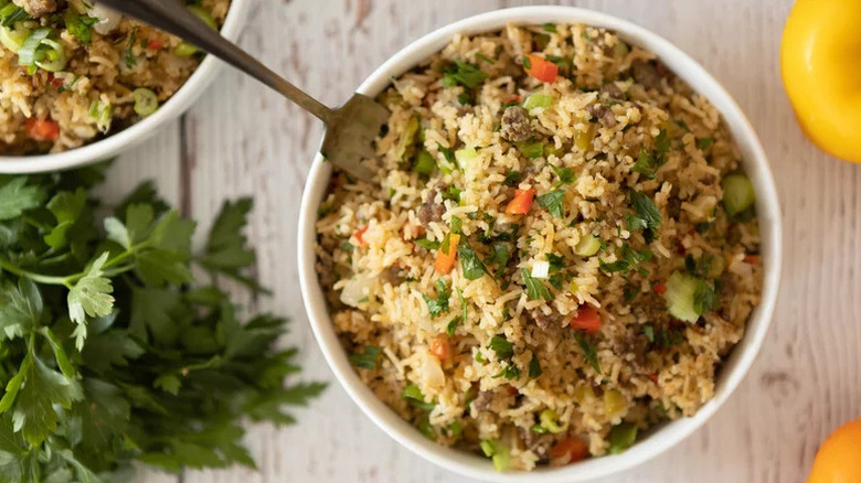 Instant Pot Dirty Rice in white bowl with fork