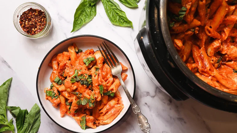 Instant Pot Penne Pasta and Creamy Tomato Sauce in bowl with silver fork