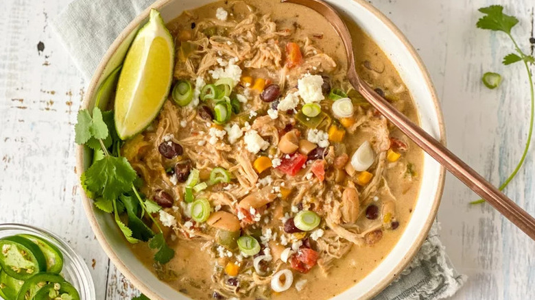 Instant Pot White Chicken Chili with herbs and lime in white bowl