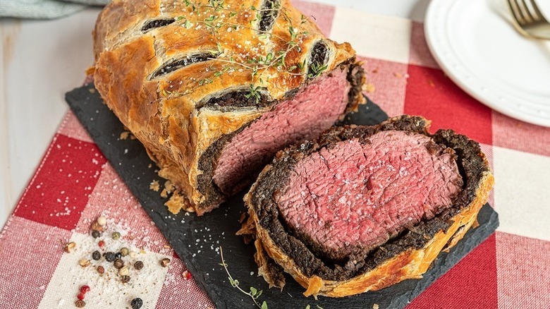 Sliced beef wellington on serving platter