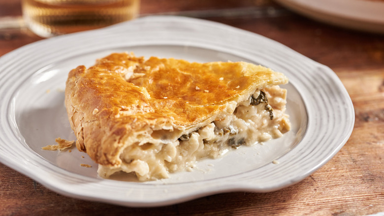 Slice of spinach and feta chicken pot pie on plate