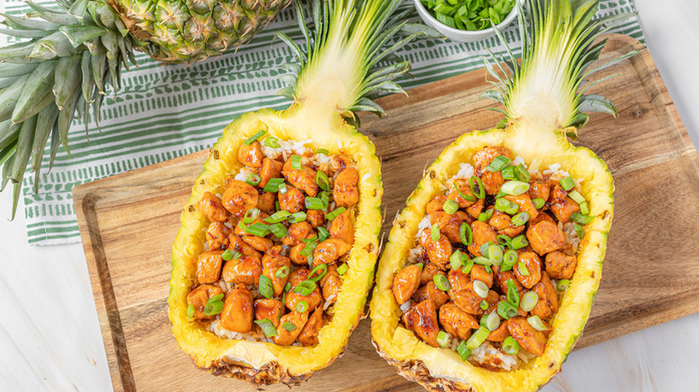 Teriyaki chicken served in halved, hollowed pineapple