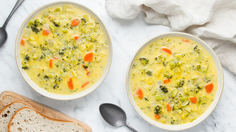 Two bowls of broccoli cheddar soup
