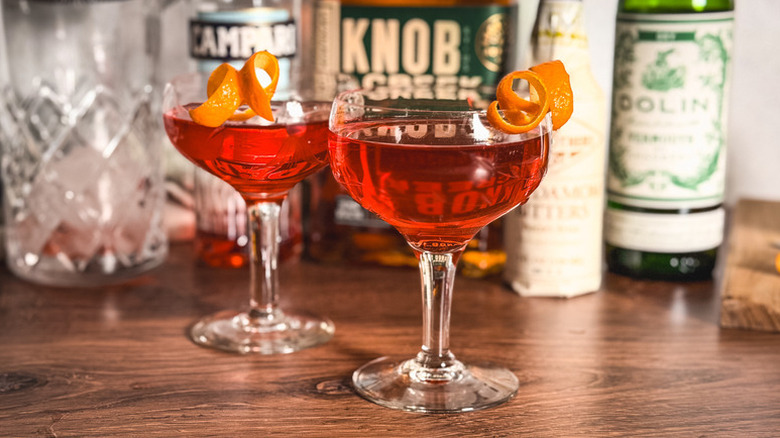 Two old pal cocktails in coupe glasses, each garnished with an orange twist