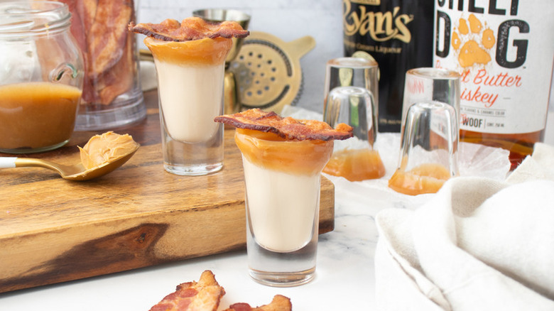 Creamy whiskey shots topped with peanut butter and crispy bacon slices