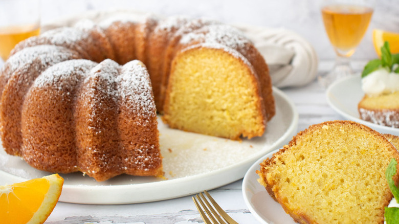 Orange bundt cake sliced and served onto plate
