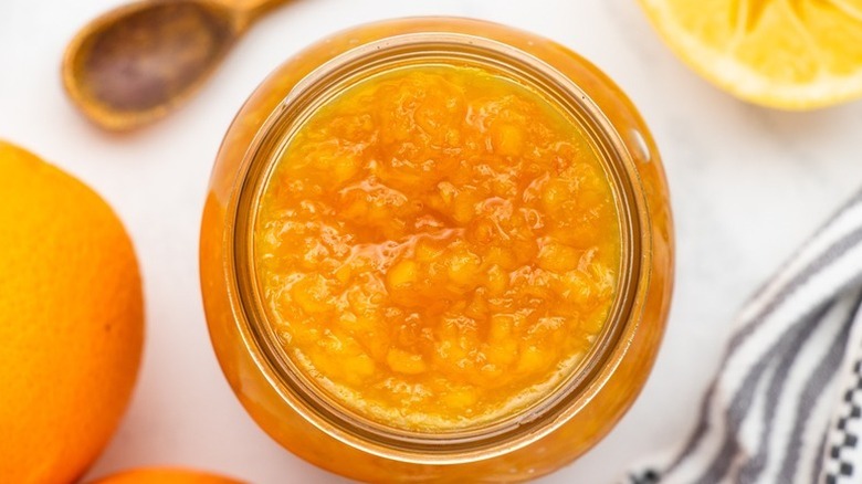 Top down view of orange marmalade in glass jar