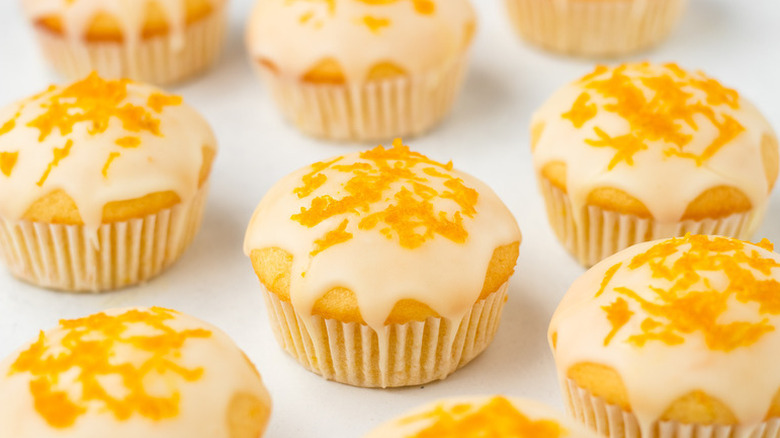 Orange muffins, topped with orange glaze and fresh orange zest