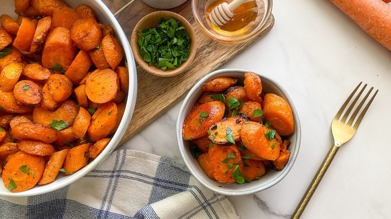 Honey-glazed carrots served into bowl and garnished with parsley