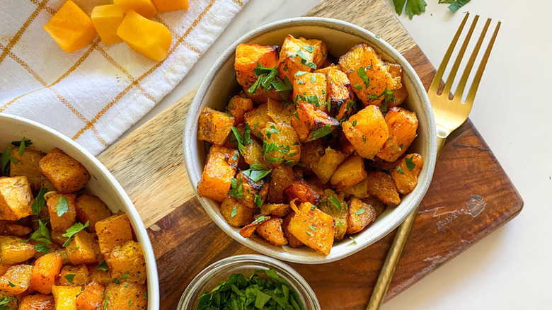 Maple-roasted squash in bowls, garnished with chopped parsley